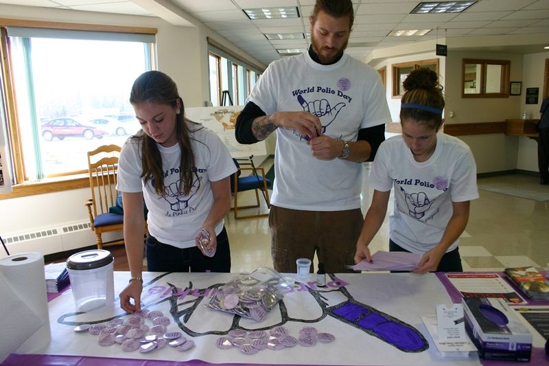 Bio-Med Club students working a booth for the Purple Pinky Project