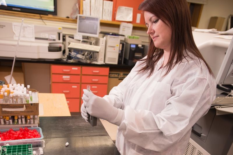 an MLT student running a test at a lab table