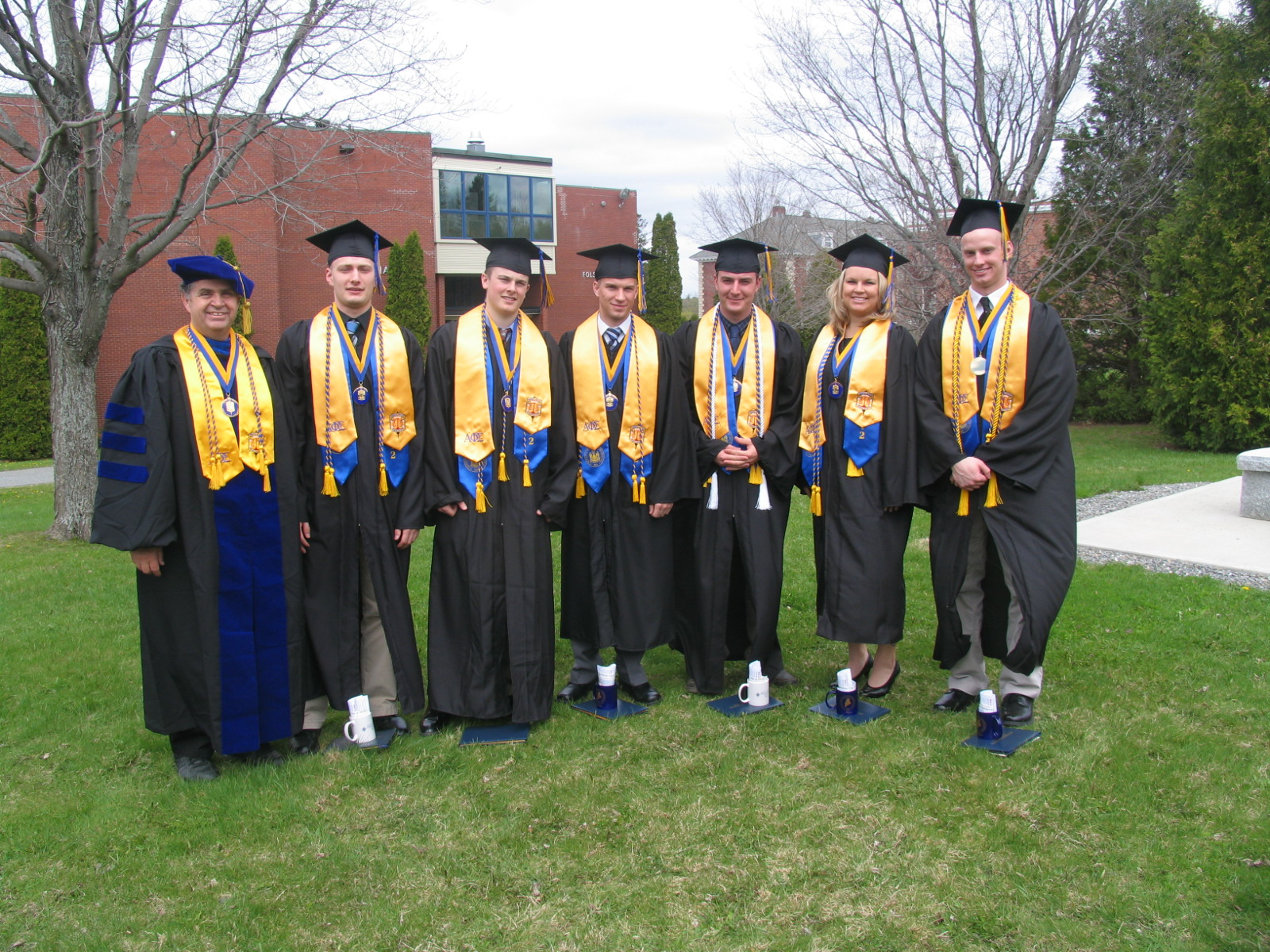 Seven decorated graduates smiling