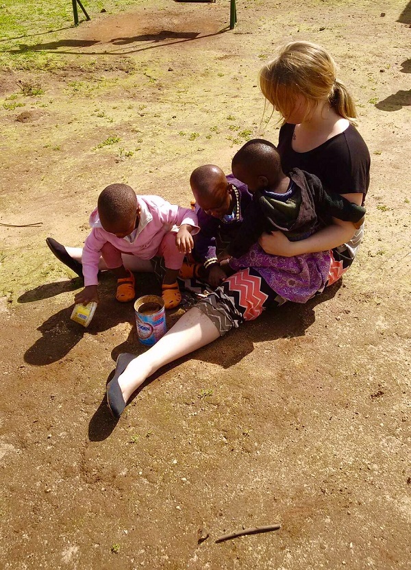 Photo of Alyssa Summerson with three children in Tanzania