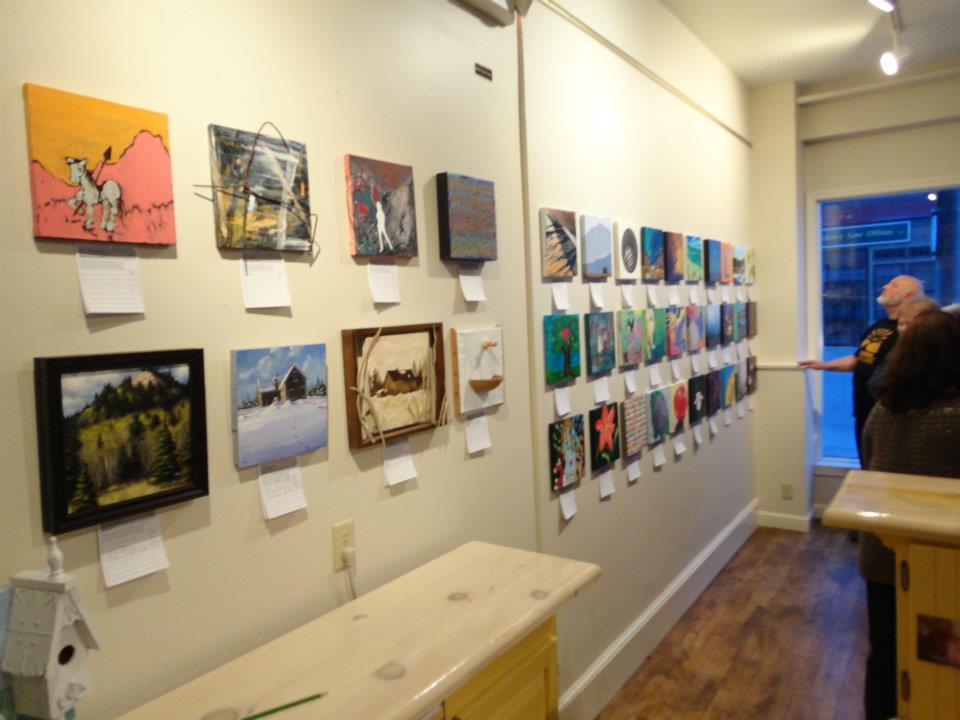 Photo of paintings on a wall for an art exhibit