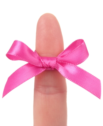 Photo of pink ribbon tied around an index finger