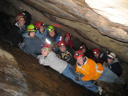 Photo of eleven students exploring a cave