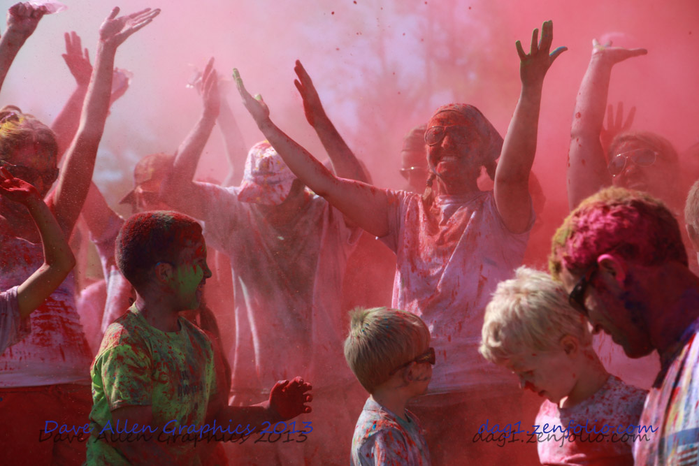 Photo of runners covered in colored powder