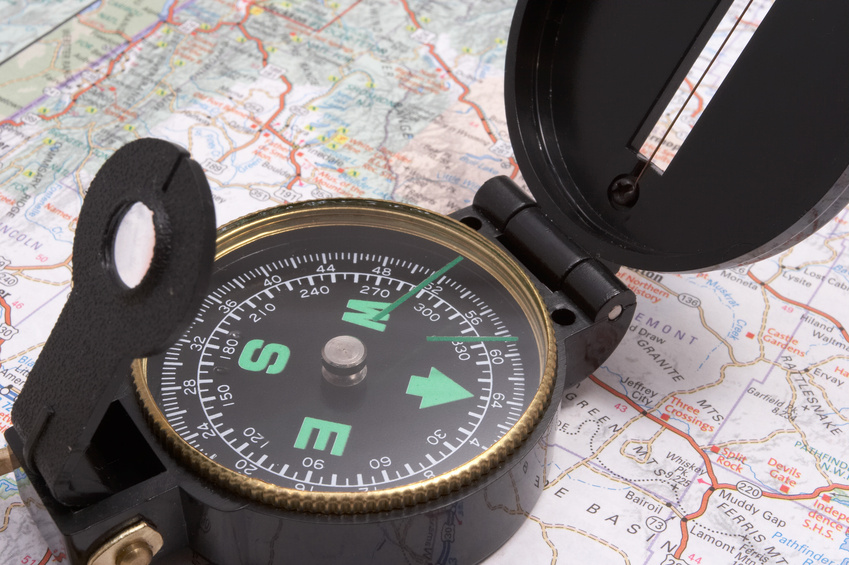 Photo of a compass sitting on a map