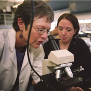 Photo of professor and student using a microscope