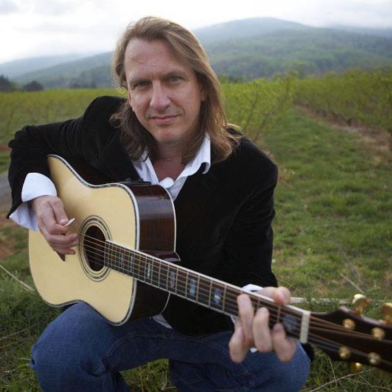 Photo of Ellis Paul holding a guitar