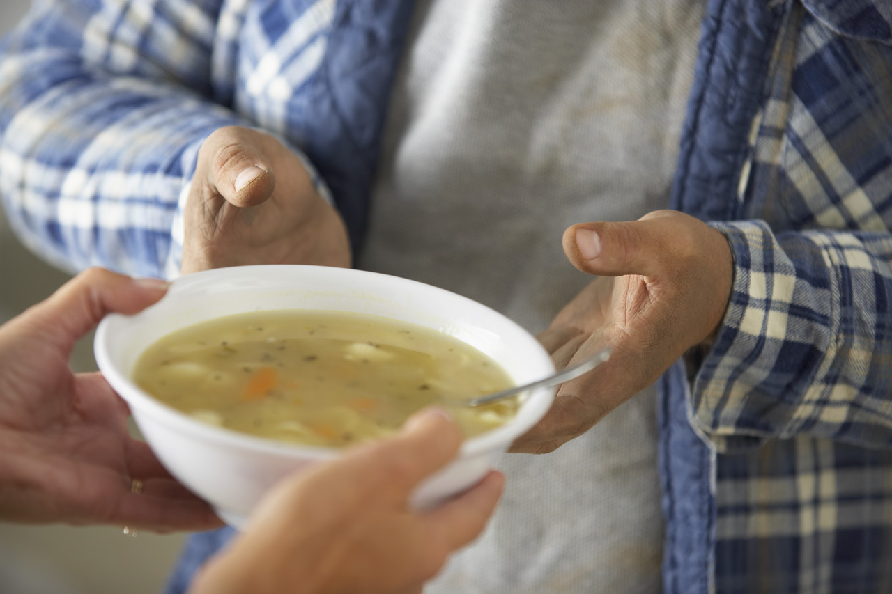 Hands of Homeless Man Receiving Bowl of Soup --- Image by © Royalty-Free/Corbis