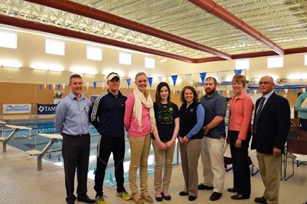 Photo of eight community partners next to the Gentile Hall Pool