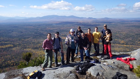 Photo of nine geology students on top of a mountain