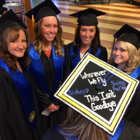 Photo of five graduates with decorated cap with text "Wherever we fly, this isn't goodbye"