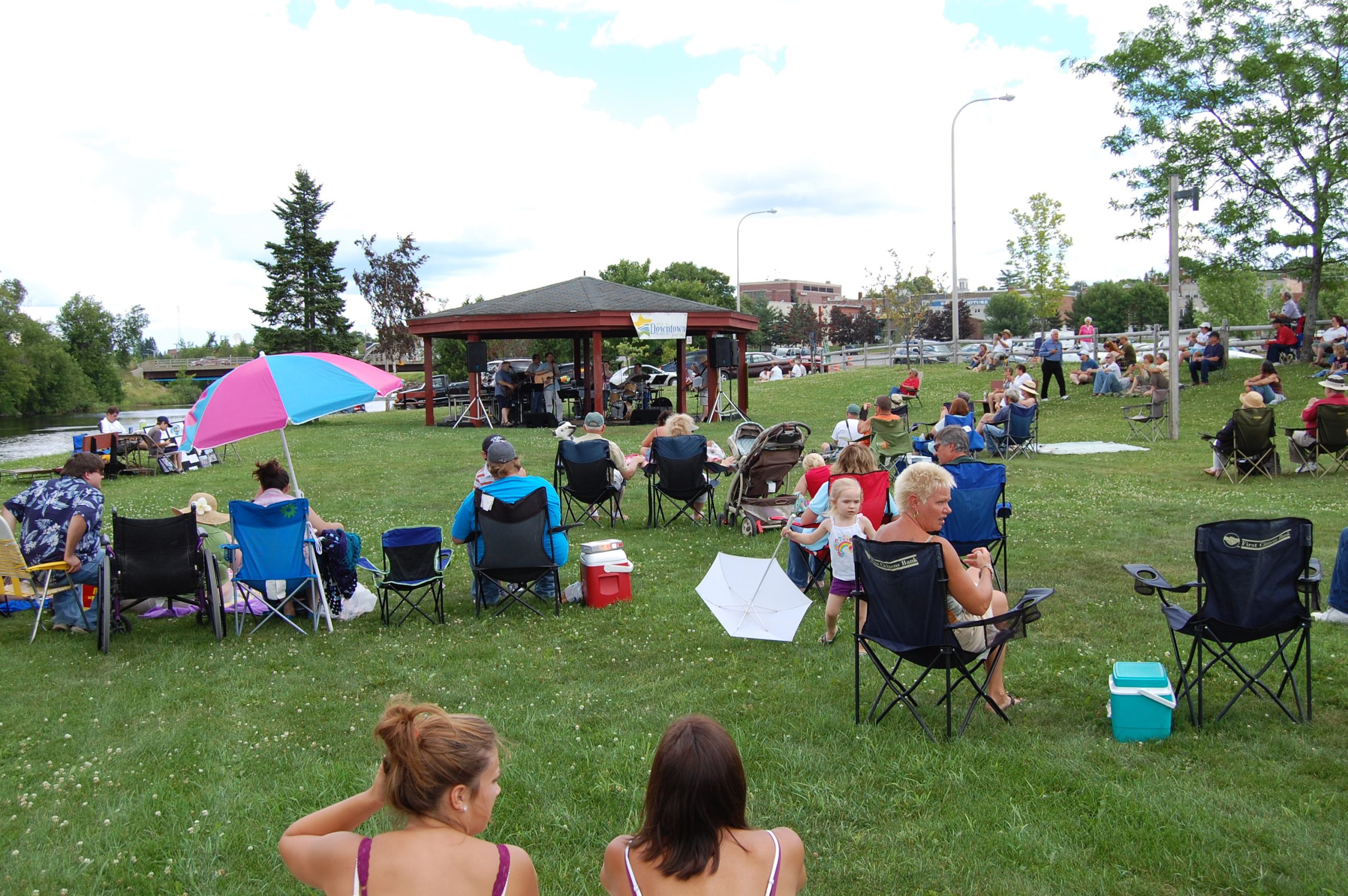 Photo of people in lawn chairs in the park at the "Music in the Park" festival