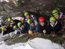 Photo of nine people exploring a cave