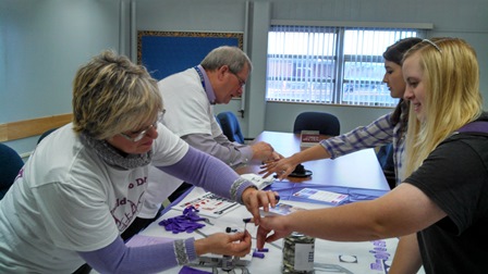 Photo of four people participating in the Purple Pinky Project