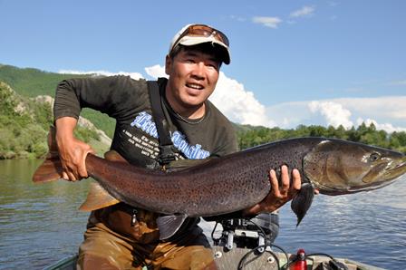 Photo of Dr. Olaf Jensen holding a large fish