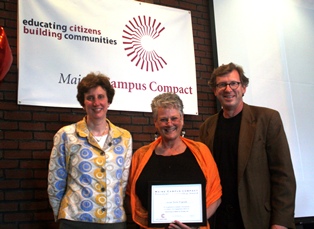 Three people accepting the President's Leadership Award