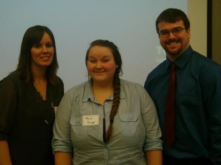 Photo of three UMPI students who delivered a tax seminar presentation