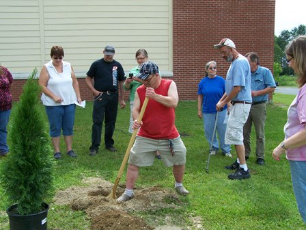 Photo of a group of people planting a tree