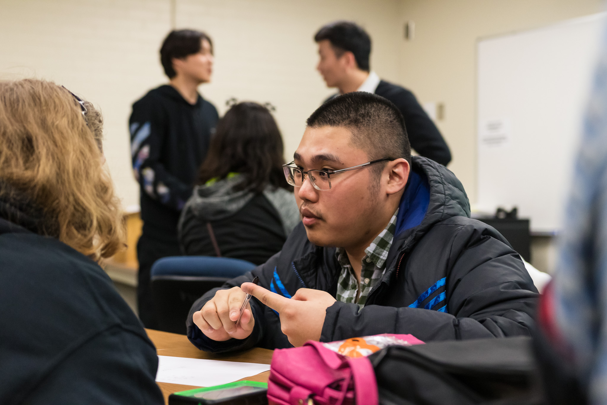 Photo of students conversing in a classroom