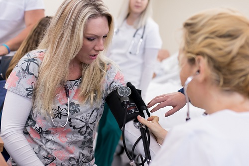 Nursing students take blood pressure measurements in the Pullen Hall nursing lab.