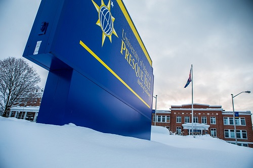 UMPI sign in front of Preble Hall in winter.