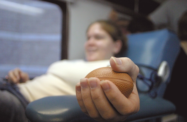 Photo of woman giving blood, focused on her hand