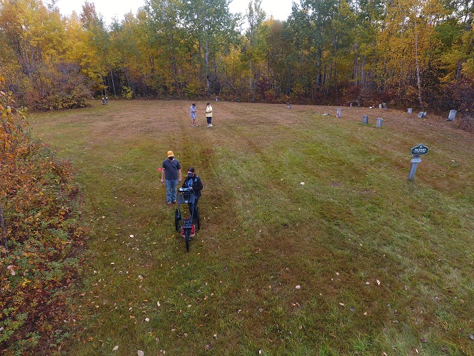 Dr. Kimberly Sebold works with ArcGIS Online students conducting cemetery mapping in central Aroostook County.