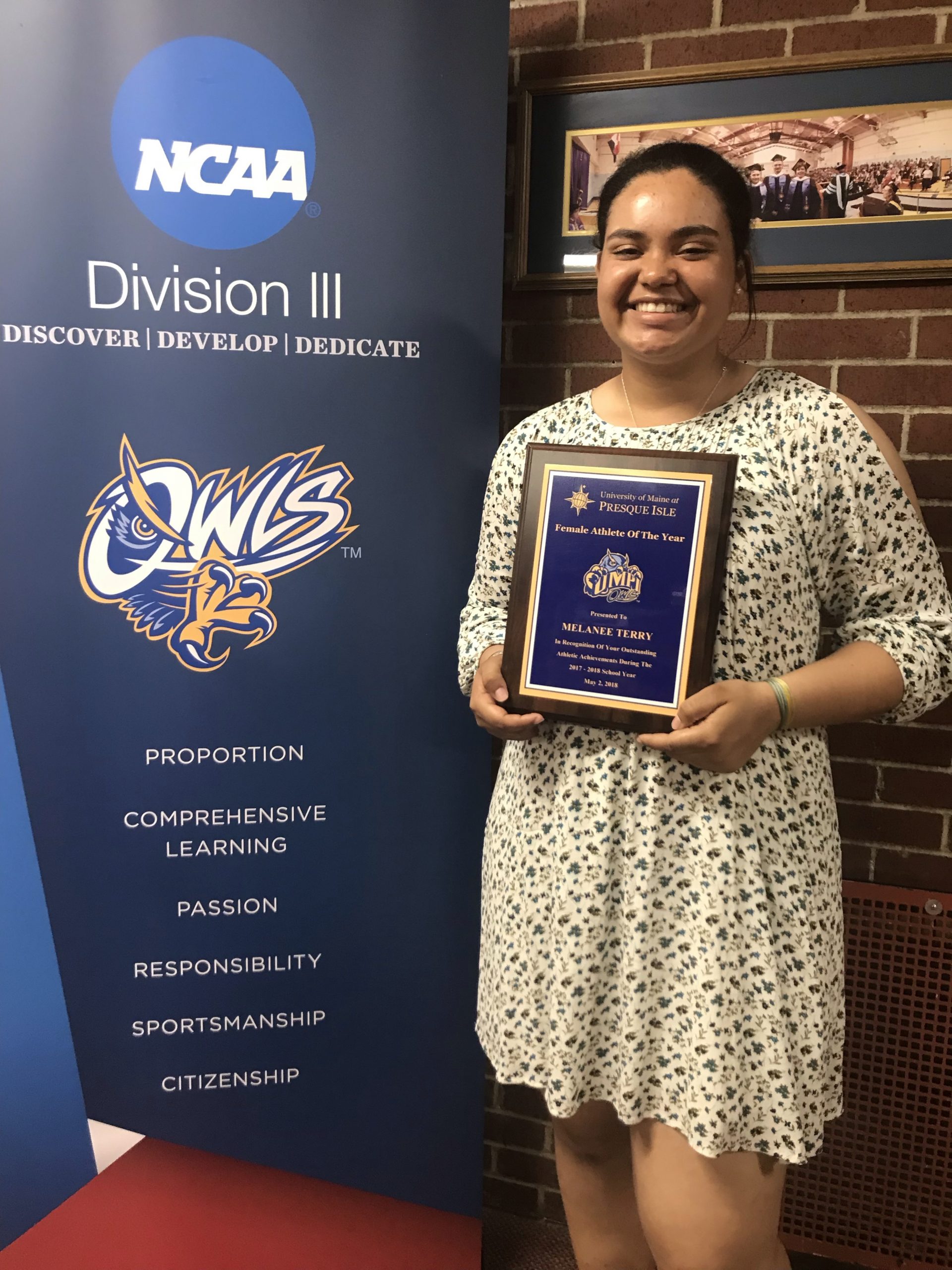 Photo of Melanee Terry holding "Female Athlete of the Year" award